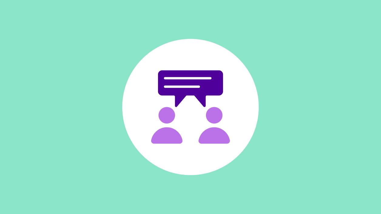 Purple icon of two people having a conversation, a chat bubble between them